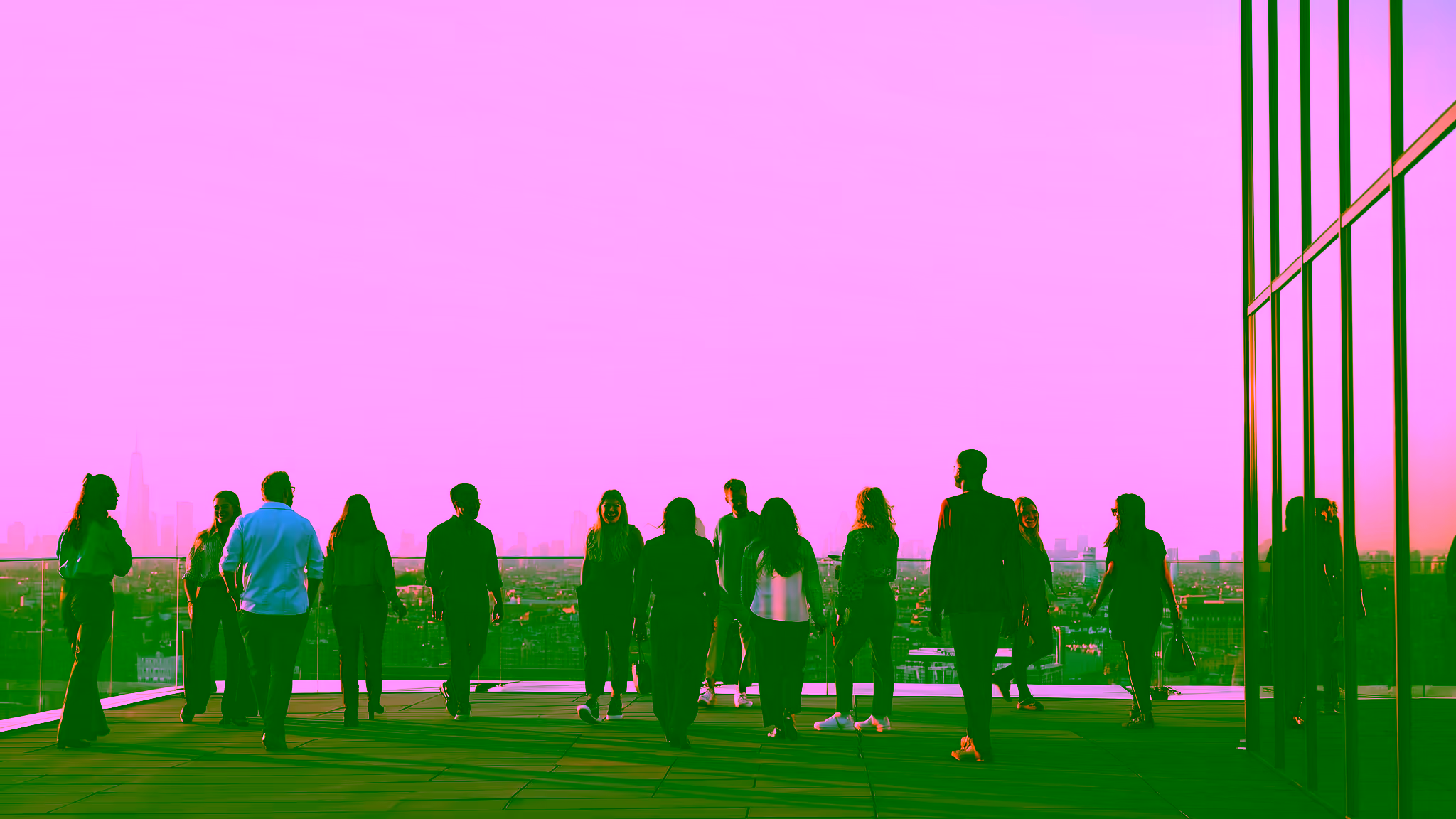 Diverse professionals collaborating on rooftop terrace at sunset